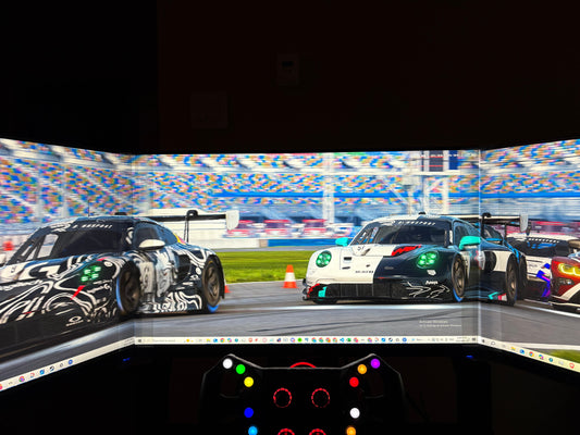 Racing game screen showing two cars on a track with triple monitors using bezel free kit.