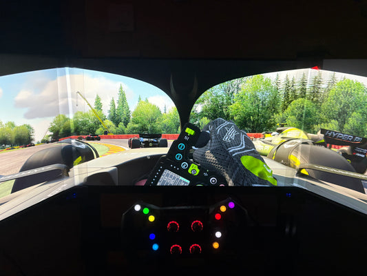 Racing simulator view from inside a car with a bezel free kit connecting triple 27' monitors
